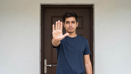 man holding out his hand to stop in front of his house generated with Z-Image